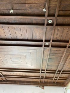 the ceiling is made of wood and has metal bars