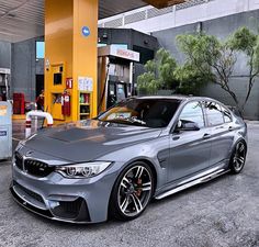 a silver car parked in front of a gas station