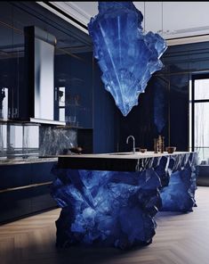 an artistic bathroom with blue marble countertops and wood flooring, along with black cabinets