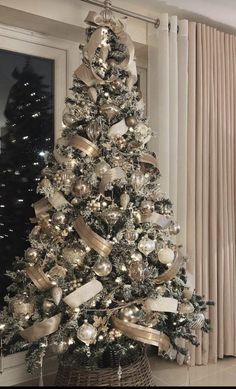 a christmas tree with gold and silver decorations