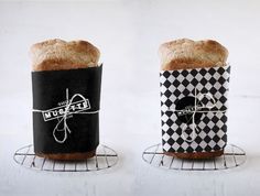 two breads sitting on top of metal racks with black and white designs in them