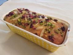 a yellow and white container filled with food on top of a table