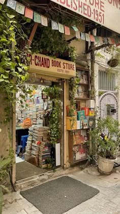 a book store with lots of books on the shelves and plants growing out of it