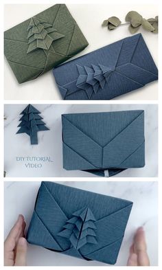 an origami christmas tree made out of blue paper and folded in green fabric