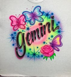 a t - shirt with the word genna painted on it and butterflies around it