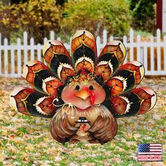 a decorative turkey statue sitting in the grass