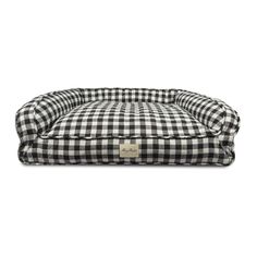 a black and white checkered dog bed with a tag on the bottom of it