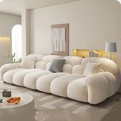 a large white couch sitting in a living room