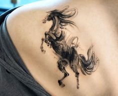 a woman with a horse tattoo on her back