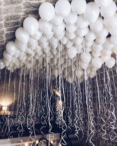 white balloons are hanging from the ceiling