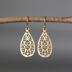 "Beautifully detailed matte gold vermeil filigree teardrop charms simply dangle from gold vermeil balled earwires. Incredibly lightweight, these go-with-everything earrings complete any outfit for daytime or evening. These earrings are also available in silver. Gold charms: 13x26mm Total length of earrings: 1 1/2\" All gold is 18k gold vermeil. As the owner, maker, designer, and curator of this shop, I take great pride in providing you with jewelry that you will love to wear everyday, for specia Gold Teardrop Earrings With Intricate Design, Gold Teardrop Earrings With Intricate Design As Gift, Dainty Gold Earrings With Elegant Design, Elegant Matte Gold Earrings For Formal Occasions, Gold Teardrop Earrings With Elegant Design As A Gift, Filigree Brass Teardrop Earrings, Brass Filigree Teardrop Earrings, Teardrop Brass Filigree Earrings, Gold Teardrop Earrings With Elegant Design