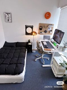 a bedroom with a bed, desk and computer