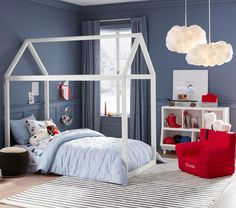 a child's bedroom with blue walls and white furniture