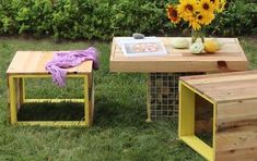 a table made out of pallets with sunflowers in the middle and a book on top