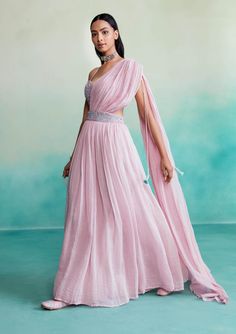 Introducing "bloomsy" - where elegance meets comfort! Our orchid pink bloomsy skirt saree is a one-of-a-kind creation, featuring a hand-embroidered bustier blouse adorned with mesmerizing double buttonhole stitches and shiny cutdanas. What sets this ensemble apart is its innovative design, allowing the dupatta to seamlessly attach to the skirt, granting you the look of a saree without the hassle of draping. Traditional Pink Draped Lehenga, Traditional Draped Pink Lehenga, Pink Floor-length Evening Lehenga, Evening Floor-length Pink Lehenga, Elegant Draped Pink Lehenga, Anarkali Draped Dress With Pallu, Pink Anarkali Lehenga For Evening, Fitted Floor-length Pink Pre-draped Saree, Pink Traditional Drape Dress For Spring