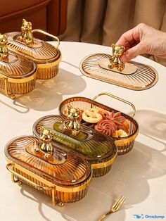 a table topped with three serving trays filled with food