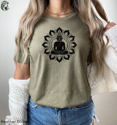 a woman wearing a t - shirt that has a buddha image on the front and back