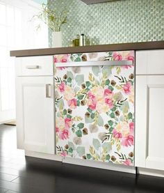 a floral dishwasher cover in a kitchen with white cabinets and black flooring