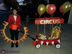 a man in a circus costume is pulling a wagon with balloons and a sign that says circus