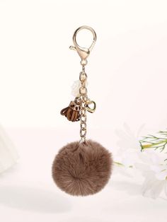 a keychain with a fur ball hanging from it