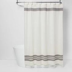 a white shower curtain with grey stripes on it