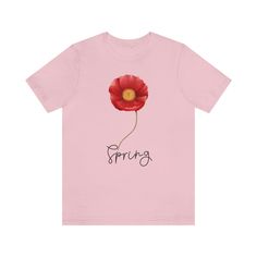 a pink t - shirt with the word spring written on it and a red flower