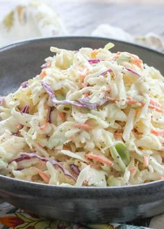 a bowl filled with coleslaw salad on top of a table