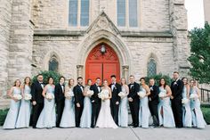 a large group of people standing in front of a church