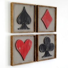 three framed pieces with playing cards in them on a white wall next to each other