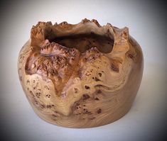 a wooden bowl that has been carved to look like a mountain