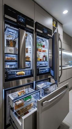 two refrigerators with their doors open in a kitchen