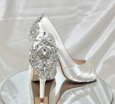 "Bridal Shoes with crystal back design. Dyeable Wedding Shoes.  Shoes in listing are Light Ivory.  Wedding shoes available in over 100 additional colors, including white.  We can also color match a sample you send us.   If you pick chart color or David's Bridal color from the menu, please put the color you would like in the personalization box. These beautiful wedding shoes have a 4 1/4\" heel and a 1/2\" hidden platform. Pick from my color chart or send us a color swatch to match. DYE COLORS: M White Satin Wedding Shoes, Ivory Heels Wedding, Satin Wedding Shoes, Ivory Bridal Shoes, Beautiful Wedding Shoes, How To Dye Shoes, Fancy Clothes, Ivory Wedding Shoes, Crystal Heels