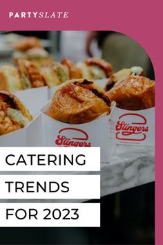 a table topped with lots of different types of food next to a pink sign that says catering trend for 2013