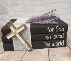 three books stacked on top of each other with the words for god so loved the world