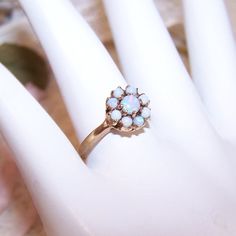 Dating Anywhere From The Late 1880s To Early 1900s, May I Offer This 10k Yellow Gold (Hallmarked As Pictured) Sweetheart, Possible Engagement Ring Featuring 9 Natural Round Cab Opals. Color To The Stones Is Lovely With Flashes Of Pink And Blue Against A White Background - No Chips Or Cracks That I Can Spot. Design On Top Measures 3/8" Across. Ring Size Is 6.25; Weight Is 2.1 Grams. Makers Initials Are Sa For (I Believe) The Samsan Company Of Providence, Ri - Makers Of Women's Stone Rings In Both Natural Opal Ring, Spot Design, Providence Ri, May I, Pretty Rings, Opal Ring, Natural Opal, Early 1900s, Antique Victorian