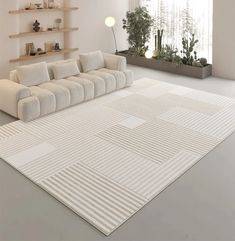 a large white couch sitting on top of a rug