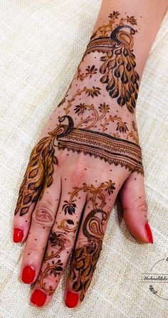 a woman's hand with henna tattoos on it