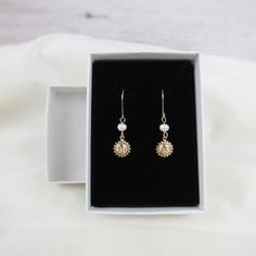 Perfect for sunny days, you'll love our gold sun earrings for their simple design and very dainty nature. Charms and ear wires are 14k gold filled making these earrings excellent quality and perfect for everyday wear! Materials: 14k gold filled wire Beads: freshwater pearls and gold filled charm (one-sided, 8mm) Sizing Details: (earring box is 2x3 inches for size reference) Total Length: 1.25 in. (3cm) Width: .3/8 in. (.75cm) Everyday 14k Gold Filled Earrings With French Hook, 14k Gold Filled French Hook Earrings For Everyday, Everyday 14k Gold Filled French Hook Earrings, Nickel-free Dainty 14k Gold Filled Earrings, Dainty Adjustable Earrings With French Hook, Dainty Adjustable French Hook Earrings, Dainty 14k Gold Filled Nickel-free Earrings, Dainty Gold Jewelry With French Hook, Dainty Hypoallergenic Recycled Gold Earrings