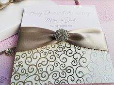 a close up of a wedding card with a bow on it's front and back