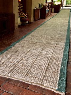 a large rug is on the floor in front of a window