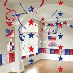 red, white and blue streamers are hanging from the ceiling in an empty room