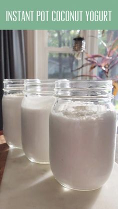 three jars filled with coconut yogurt sitting on top of a table