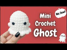 a crochet ghost is being held up in front of a red background with the words mini crochet ghost on it