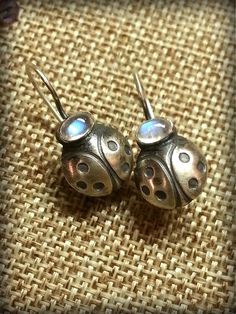 "Moonstone Ladybug Earrings, Gemstone Ladybugs, Adularia Moonstone Earring, June Birthstone Earrings, Insect Earring, Moonstone Stud Earrings, a unique gift for a Gardener I crafted our Moonstone Ladybugs from Sterling Sheet Metal and formed into little domes of the popular beetle, the familiar shape found in many homes & gardens. Each is bejewled with a pair of hand selected, luscious and luminous Adularia Blue Flash Moonstone Cabochons, a birthstone for June. Our Ladybugs set with deeper s Nickel-free Moonstone Spiritual Earrings, Nickel-free Moonstone Moon Earrings, Nickel-free Moonstone Moon-shaped Earrings, Adjustable Moon-shaped Moonstone Earrings, Unique Moon-shaped Earrings For Gift, Moonstone Earrings For Gift, Unique Moon Shaped Earrings For Gift, Artisan Moonstone Earrings For Gifts, Unique Moonstone Pierced Earrings