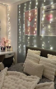 a bedroom decorated in white and silver with lights on the wall