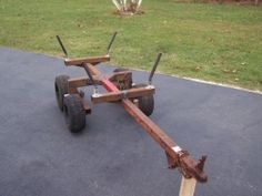 a wooden cart with two wheels on the ground