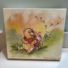 a drawing of two winnie the pooh characters playing with dandelions on a white surface