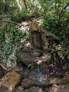 a small waterfall in the middle of some rocks