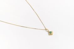 "14k solid yellow gold boho-chic pendant necklace set with a square green emerald, unique antique style India-inspired necklace for women. This regal necklace is made of 14k yellow gold and has an ornamented solid gold pendant. The pendant is set with an emerald and adorned with an arc of tiny gold dots and a lower bigger one at the bottom. This 14k solid gold necklace is beautiful and chic and will upgrade and add color to any outfit you'll wear. It is perfect for everyday use but will also sta Fine Jewelry Gold Emerald Necklace With Delicate Chain, Gold Emerald Necklace With Delicate Chain, Fine Jewelry, Fine Jewelry Gold Emerald Pendant Necklace, Emerald Pendant Necklace With Delicate Chain, Gold Emerald Jewelry With Delicate Chain, Dainty Emerald Pendant Necklace With Delicate Chain, Gold Emerald Necklace With Square Pendant, Fine Jewelry Emerald Necklace With Square Yellow Gold Pendant, Green 14k Gold Necklace, Tarnish Resistant