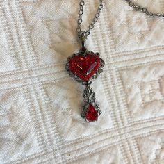 "Victorian Reproduction Red Heart Necklace. Cut Heart Stone With Ring of Red Rhinestones Around Plus Teardrop Dangle in Swirling Setting. Nickel Free and Lead Free. Great for costuming wear. This necklace is in good shape. Size: Pendent; 5/8\" X 1 1/4\" For other animal jewelry and vintage items see: www.VeryVictorianStudio.etsy.com For sewing related items see my other shop: www.SewingRoomStore.etsy.com Thank you for looking!" Affordable Red Amulet Style Jewelry, Luxury Victorian Jewelry For Valentine's Day, Red Heart Beads Pendant Jewelry, Vintage Red Jewelry With Heart Beads, Red Crystal Pendant Jewelry, Red Drop Beads For Jewelry Making, Heart-shaped Jeweled Jewelry Gift, Heart-shaped Jeweled Jewelry For Gift, Heart Shaped Jeweled Jewelry For Gift